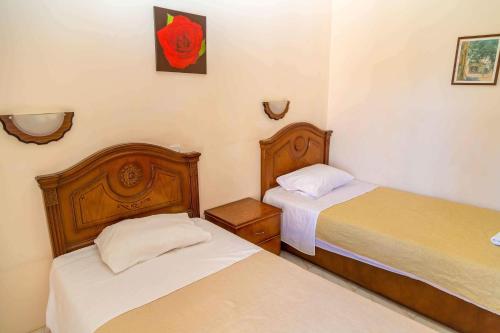 two beds in a small room with twoermottermott at Chrysanthos Boutique Apartments in Limassol