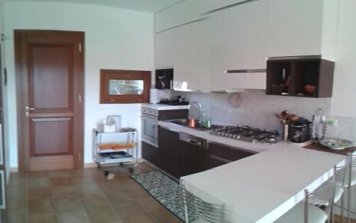 a kitchen with a sink and a stove top oven at monte moro in Arzachena