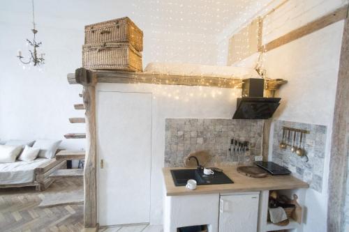 a room with a kitchen with a sink and a bed at Overture Studio in Kamianets-Podilskyi
