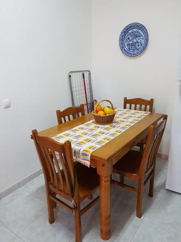 a dining room table with a bowl of fruit on it at Quinta Teresinha in Silves