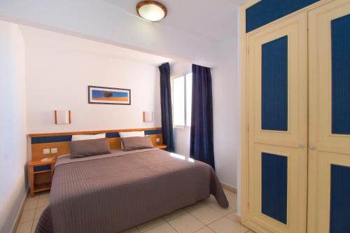Llit o llits en una habitació de Apartamento Faro