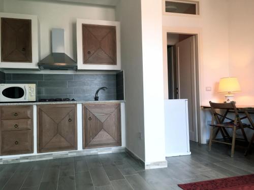 a kitchen with a sink and a stove top oven at Appartamento Sole e Mare in Palau