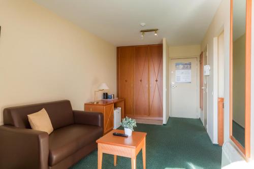 a living room with a couch and a table at Seaside Blankenberge in Blankenberge