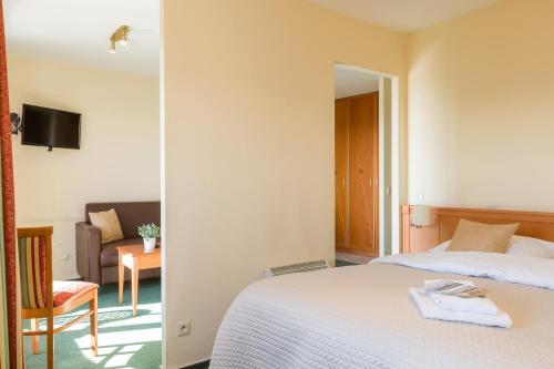 a hotel room with a bed and a chair at Seaside Blankenberge in Blankenberge