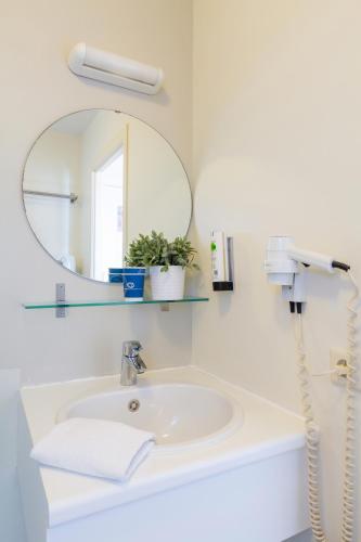 a bathroom with a sink and a mirror at Seaside Blankenberge in Blankenberge