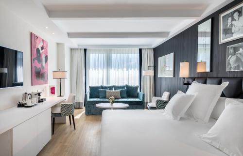 a bedroom with a bed and a living room at Barceló Imagine in Madrid