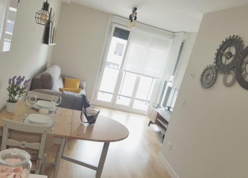 a living room with a table and a couch and a table at Smart Urban Orio in Orio
