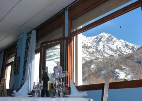 a window with a view of a snow covered mountain at Hotel Garona in Bossost