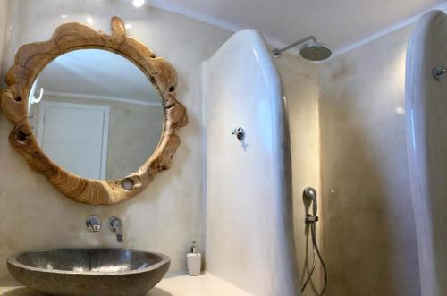 a bathroom with a sink and a mirror at Villa Elina suites and more in Agios Stefanos