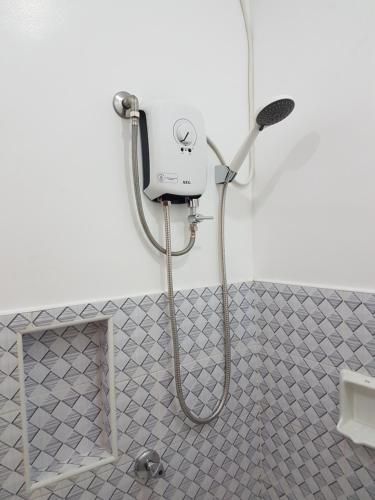 a shower in a bathroom with a shower at Kdc Homes in Puerto Princesa City