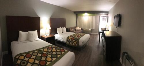 a hotel room with two beds and a couch at Ocean's 24 in Virginia Beach