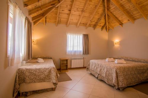 a room with two beds and a window at Patagonia Hostel in El Chalten