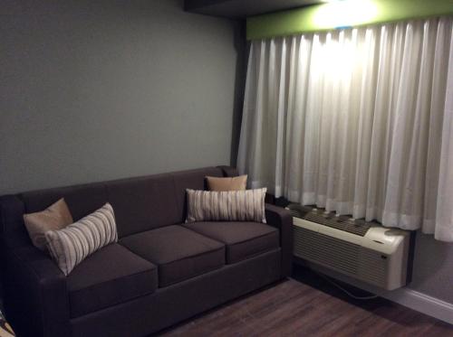 a living room with a couch and a window at Ocean's 24 in Virginia Beach