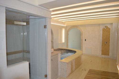 a large bathroom with a tub in the middle at Rozmari and Spa in Agia Galini