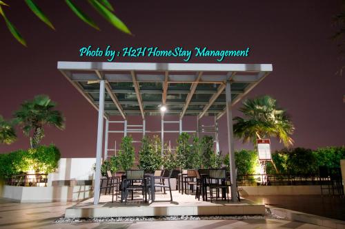 a group of tables and chairs in front of a building at H2H - Swiss Home - Majestic Ipoh in Ipoh