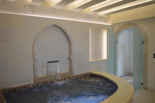 a room with a swimming pool in the middle of the room at Rozmari and Spa in Agia Galini