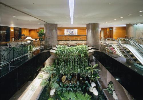 a large room filled with lots of plants and flowers at The Kimberley Hotel in Hong Kong