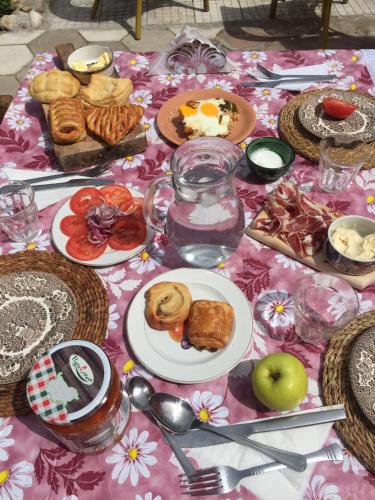 a table with plates of food on a pink table cloth at The Pink House in Polkownik Serafinowo