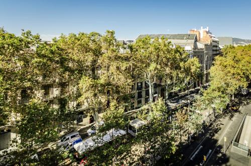 an overhead view of a city street with trees at Exe Ramblas Boquería in Barcelona