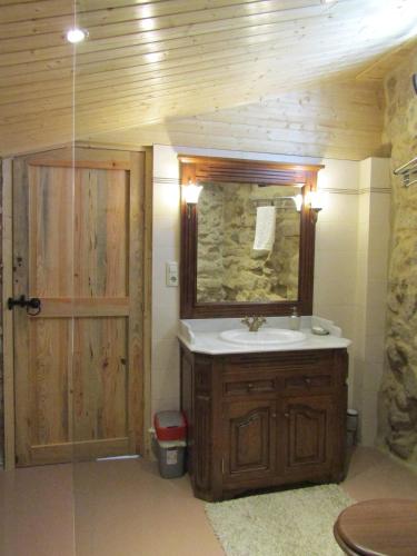 a bathroom with a sink and a mirror at Hostal Casa Martinez in Bueu