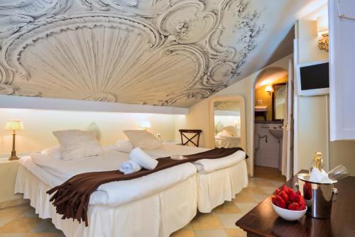 a bedroom with a large bed with a coffered ceiling at The Town House in Marbella