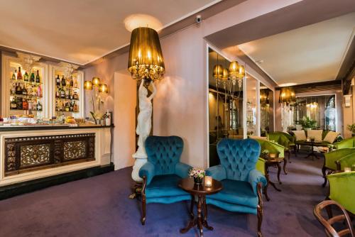 a bar with chairs and a statue in a room at The Town House - Adults Only in Marbella