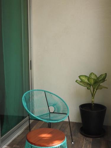 a chair and a table and a potted plant at Villas H2O in Tulum