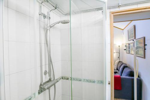 a shower with a glass door in a bathroom at Comfortable Cottage at Scenic Lake in Landvetter