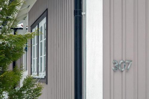 a door with a number on the side of a house at Comfortable Cottage at Scenic Lake in Landvetter