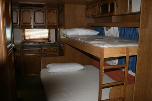 a small room with a bunk bed in a trailer at Camping Victoria in Capaccio-Paestum