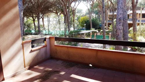 a balcony with a large window looking out at a park at Mare a Santa Margherita in Pula