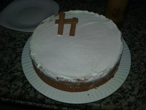 a white cake with a cross on a paper plate at Pousada Irashai in Juquei