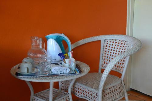 a table and a chair with a tray on it at Seelo Guest Accommodation in Letlhakawe