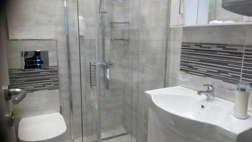 a bathroom with a shower and a sink at M&N Central Apartment in Plovdiv