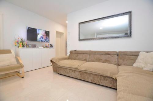 a living room with a couch and a television at Apartments Valentino in Gradac
