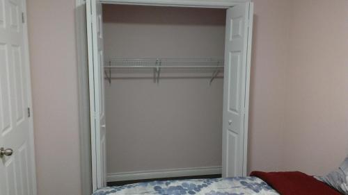 a closet with a mirror and a bed in a room at HB Guest Home 5 in Waterloo