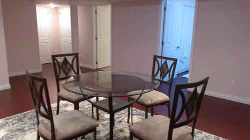 a glass table and four chairs in a room at HB Guest Home 5 in Waterloo