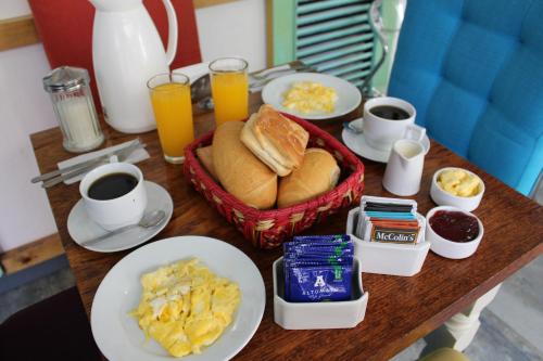 a breakfast of eggs, toast, fruit, and coffee at La Casa del Viajero in Lima