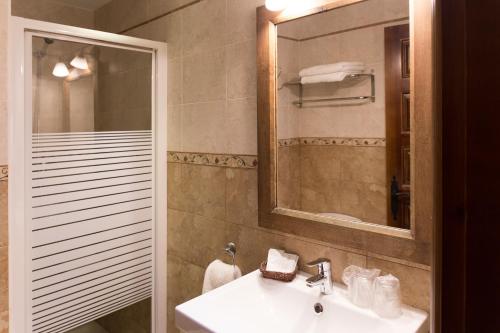 a bathroom with a sink and a mirror and a shower at Casa Rural Flor de Vida - B&B in Lizaso