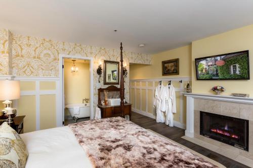 a bedroom with a bed and a fireplace at Mirabelle Inn & Restaurant in Solvang