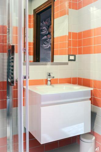 a bathroom with a white sink and a mirror at Racconti di Mare - 5 Terre JRE in La Spezia
