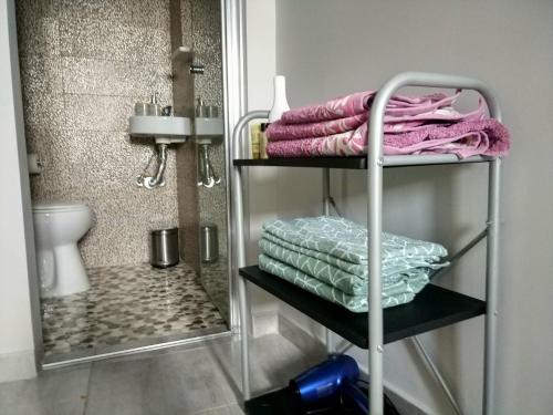 a towel rack with towels on it in a bathroom at Little Romantic Appartment in Agrinio