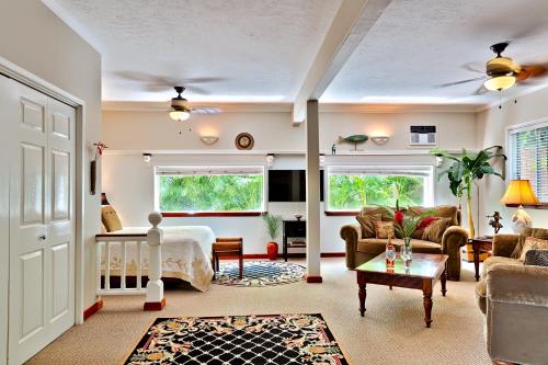 a living room with a couch and a table at Orchid Tree B&B in Hilo