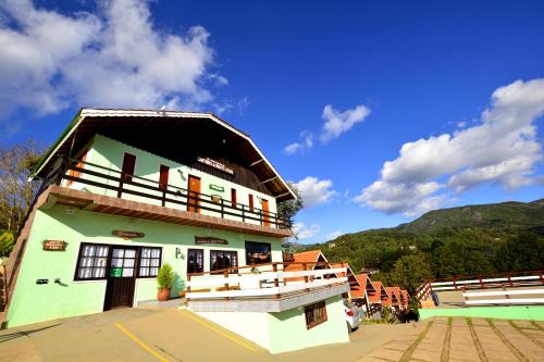 a building with a roof on top of it at Pousada Cantinho De Monte Verde in Monte Verde