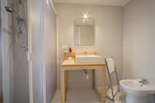 a bathroom with a sink and a toilet and a shower at Tramura Guest House in Trapani