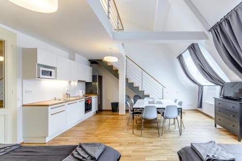 a kitchen and dining room with a table and chairs at Riverside SPIRIT in Prague