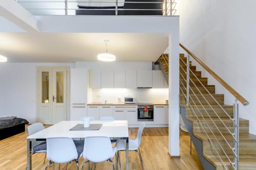 a kitchen and dining room with a table and chairs at Riverside SPIRIT in Prague