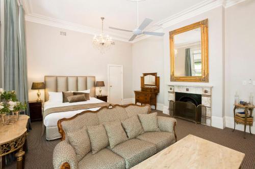 a living room filled with furniture and a fireplace at The Hughenden Boutique Hotel in Sydney
