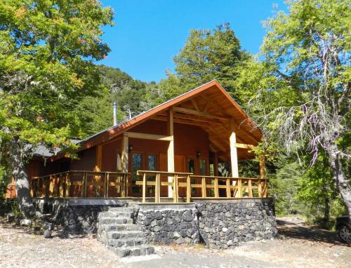 a log cabin in the woods with trees at Cabañas en Termas de Chillán in Recinto
