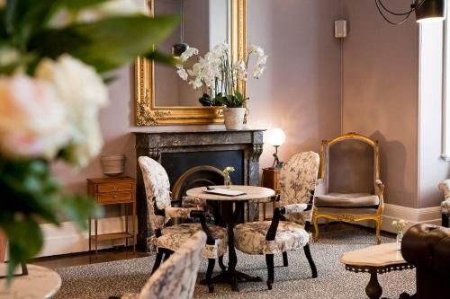 a living room filled with furniture and a fireplace at The Hughenden Boutique Hotel in Sydney